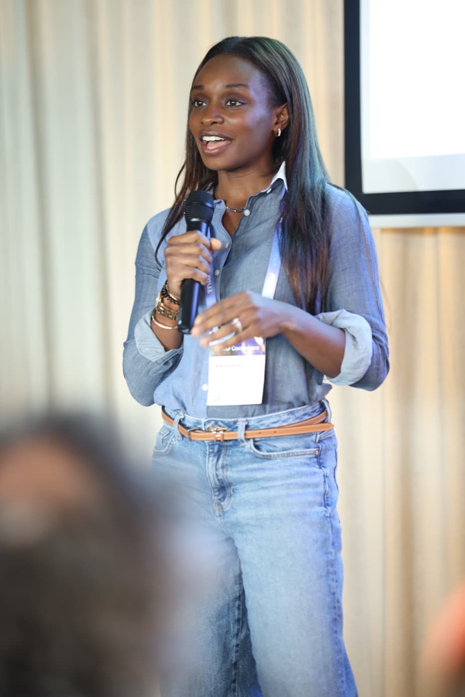 On stage, mic in hand